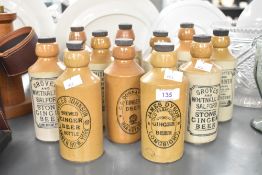 A selection of eleven 20th-century British stoneware ginger beer bottles, all of uniform shape,