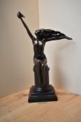 A large patinated metal figurine depicting women and bird, on marble style base, signed 'A.