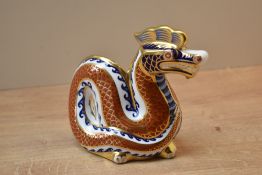 A Royal Crown Derby bone china Dragon paperweight, having Imari style decoration and silver coloured