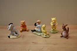 A group of three Royal Doulton bone china Winnie the Pooh characters comprising 'Winnie The Pooh and