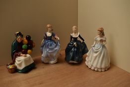 A group of four Royal Doulton bone china figurines comprising 'The Old Balloon Seller' HN 1315, '