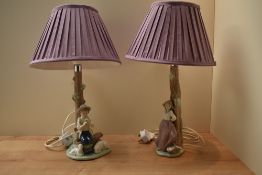 A pair of Nao by Lladro porcelain figural table lamps, depicting a young boy playing the flute and a