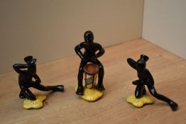 A group of three unusual Goebel porcelain figures depicting a drummer and two dancers, all in matt