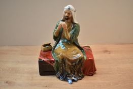 A Reg Johnson and Sons, Formerly of Royal Doulton, studio pottery figure 'The Merchant' measures
