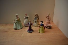 A group of four Wedgwood porcelain figurines comprising 'Goose Girl', 'Rapunzel', 'Marie Antoinette'