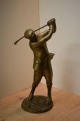 A heavy cast brass figure depicting a golfer mid-swing, measures 32cm tall.