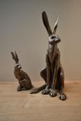 A pair of Frith Sculptures depicting two hares, largest measures 46cm tall. Damage to ears of the