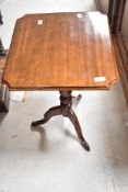 A Victorian mahogany occasional table having shaped top , turned column and triple splay legs ,