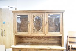 A rustic stripped pine dresser , having glazed back, section , width approx. 139cm