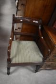 A 19th Century mahogany carver chair having drop in woolwork seat and fluted legs