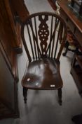 A traditional stained frame wheel back kitchen chair
