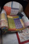 A vintage style armchair having patchwork quilt upholstery