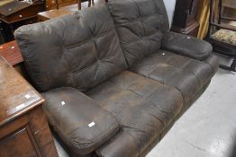 A distressed soft brown leather two seater recliner settee, width approx. 183cm