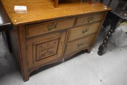 An early 20th Century oak side cabinet having Georgian style brass handles, width approx. 114cm