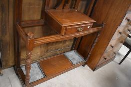 A Victorian mahogany hall stand having mirror back, with central shelf and drawer, and turned