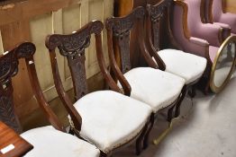 A set if late Victorian salon style dining chairs having overstuffed seats , in need of upholstery