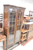 An early 20th Century oak bookcase or display case of narrow proportions, dimensions approx. W77 D28