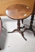 A 19th Century oak occasional table having circular top on turned column and triple splay legs,