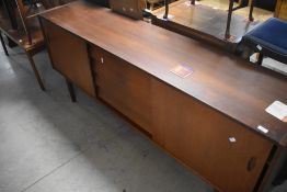 A vintage teak sideboard in the Scandinavian style having double sliding doors and central
