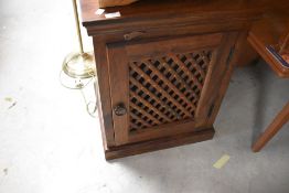 A modern 'shesham' style hifi or similar cabinet having lattice style front