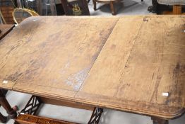A Victorian extending dining table having oak top and mahogany frame