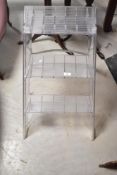 A set of vintage style clear acrylic folding steps with chrome supports