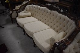 A reproduction French style three piece suite having button back cream upholstery and scroll frame