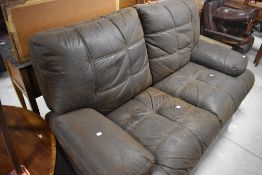 A distressed soft brown leather two seater recliner settee, width approx. 183cm
