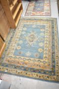 A modern rug in teal and cream, approx. 166 x 120cm