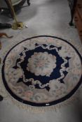 A Chinese rug of circular design having blue and cream foliate design, diameter approx. 120cm