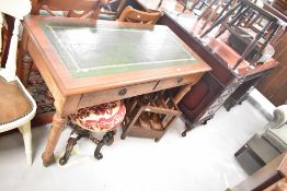 A reproduction desk on the 19th Century style having skiver top, two frieze drawers and turned