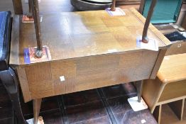 A vintage oak and ply sewing table on stylised legs, width approx. 66cm