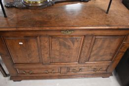 A reproduction TV cabinet with rise and fall mechanism, in the form of three panel mule chest