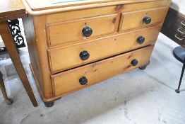 A Victorian stripped pine chest of two over two drawers having ebonised handles, width approx.