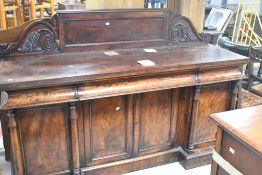 A Victorian mahogany sideboard, having concealed frieze drawer and quadruple cupboards under width