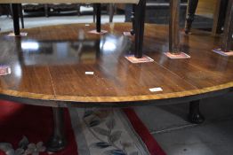 An oversized coffee table haviing Regency style top