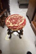 A composite stool , in the 17th Century style, with elaborate baroque scroll legs and turned cross