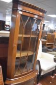 A reproduction Regency corner display with cupboard under