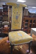 A Victorian Walnut prayer (prie dieu) chair having embroidered upholstery