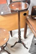 An early 20th Century mahogany wine table , having fluted column and triple splay legs, height