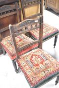 A set of three Victorian mahogany dining chairs having bobbin turned rail backs, and carpet style