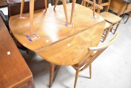 An Ercol or similar drop leaf table and set of Ercol (2065) stick back chairs