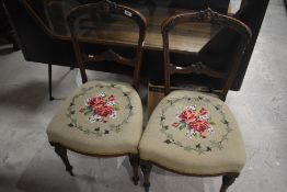 A pair of Victorian salon chairs having tapestry seats