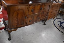 An early 20th Century mahogany sideboard having bow front, on ball and claw feet, width approx.