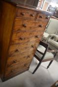 A beautiful mahogany slender bedroom chest of two short over three long drawers, by Lamb of