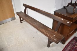 A traditional wooden bench/rustic pew, in dark stain, width approx. 213cm