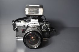 Olympus OM-10 35mm camera, with a Sigma 28-70mm f3.5-4.5 lens and an Olympus T 20 electronic flash.