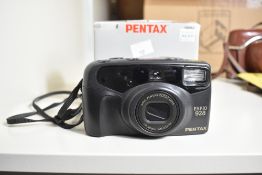 Pentax Espio 928, compact 35mm point-and-shoot film camera with a 28–90mm zoom lens.
