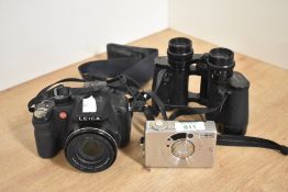 A Leica V-LUX 2 digital bridge camera and bag, a Canon IXUS II APS camera with leather case and a