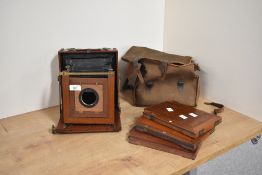A wooden plate camera, with three plate holders.